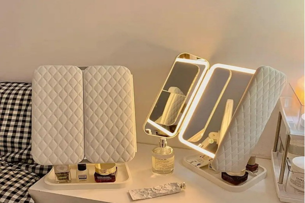 Portable folding trifold makeup mirror with LED lights and storage compartments for dressing table